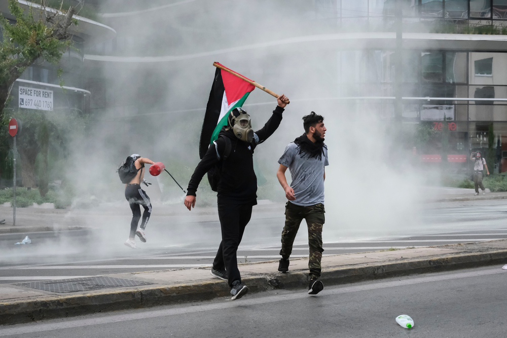 Riot,police,use,pepper,spray,and,a,water,cannon,against