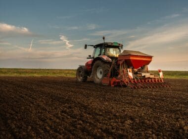 Farmer,with,tractor,seeding, ,sowing,crops,at,agricultural,field