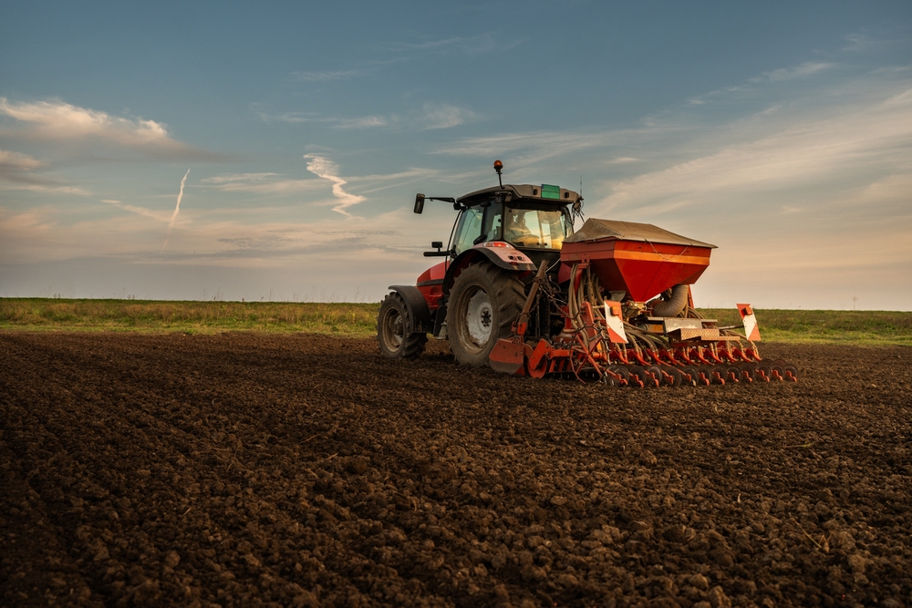 Farmer,with,tractor,seeding, ,sowing,crops,at,agricultural,field