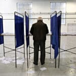 A,man,casts,her,vote,for,the,elections,for,the