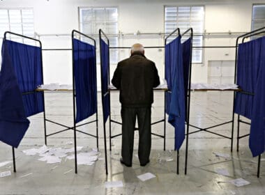 A,man,casts,her,vote,for,the,elections,for,the