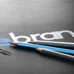 Word,rebrand,with,the,prefix,re,handwritten,over,black,paper