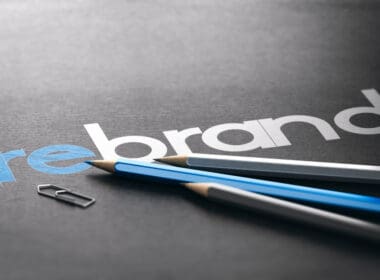 Word,rebrand,with,the,prefix,re,handwritten,over,black,paper