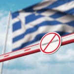Closed,boom,gate,with,no,immigration,sign,on,the,greek