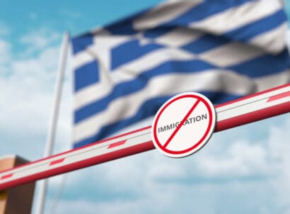 Closed,boom,gate,with,no,immigration,sign,on,the,greek
