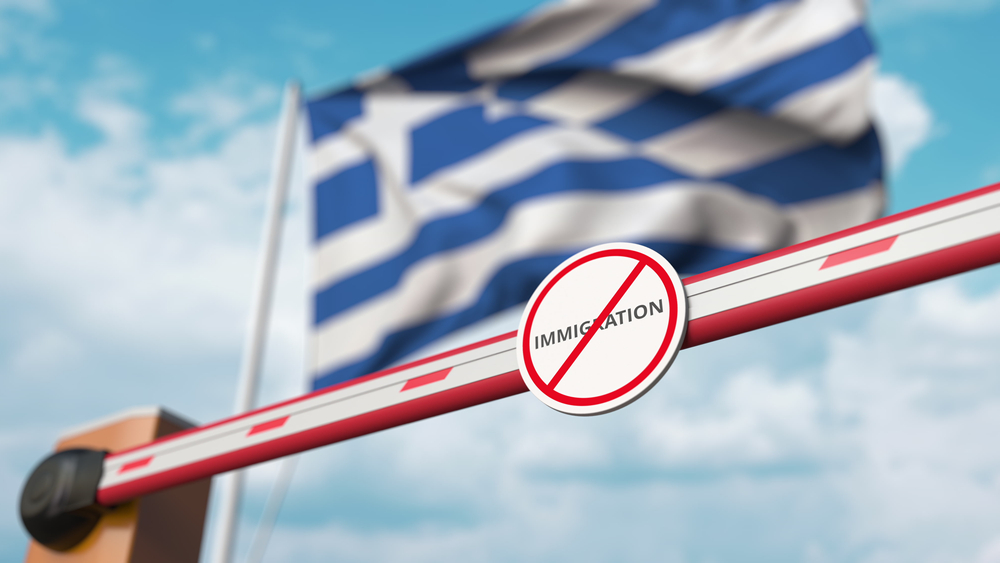 Closed,boom,gate,with,no,immigration,sign,on,the,greek
