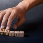 Hand,holding,dice,with,text,for,illustration,of,"voter,and