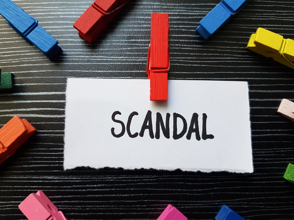 Scandal,writting,on,table,background