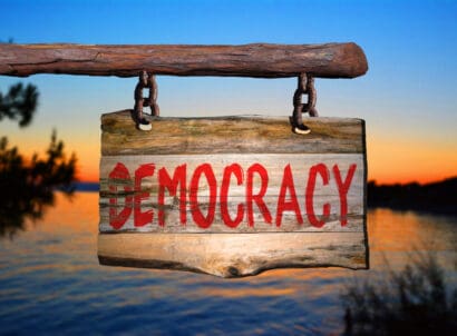 Democracy,motivational,phrase,sign,on,old,wood,with,blurred,background