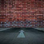 White,arrow,on,the,road,straight,to,the,old,brick