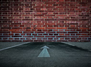 White,arrow,on,the,road,straight,to,the,old,brick