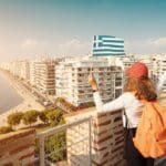 Happy,student,traveller,girl,with,a,greek,flag,on,the
