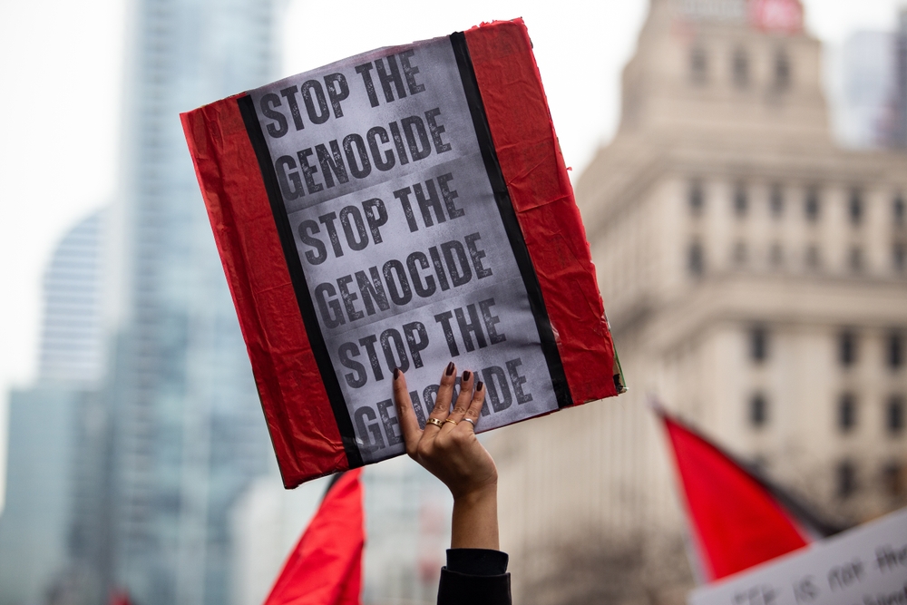 Person,holds,up,a,sign,saying,stop,the,genocide,at