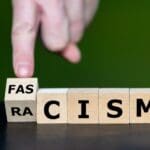 Symbol,that,racism,leads,to,fascism ,hand,turns,cube,and
