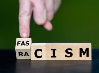 Symbol,that,racism,leads,to,fascism ,hand,turns,cube,and