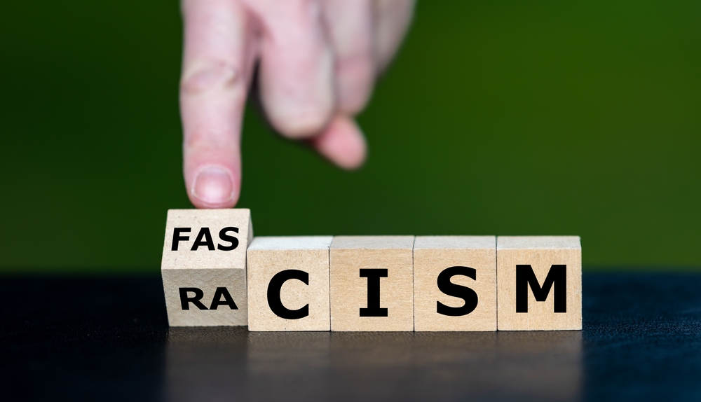 Symbol,that,racism,leads,to,fascism ,hand,turns,cube,and