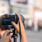 Man,hands,holding,camara,to,record,and,live,outdoor,event