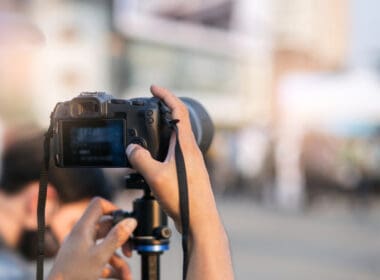 Man,hands,holding,camara,to,record,and,live,outdoor,event