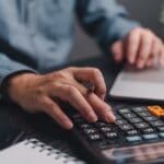 Businessman,using,calculator,bookkeeping,payroll,and,budget,tax ,business,document