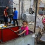 Displaced,palestinians,fill,gallons,of,drinking,water,in,khan,yunis,