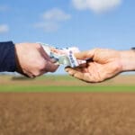 A,businessman,and,farmer,with,a,money,transfer