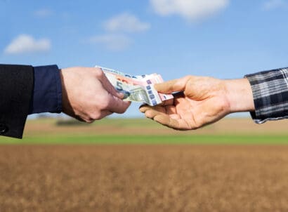 A,businessman,and,farmer,with,a,money,transfer