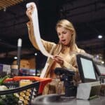 Young,sad,customer,woman,wears,casual,clothes,read,bill,at