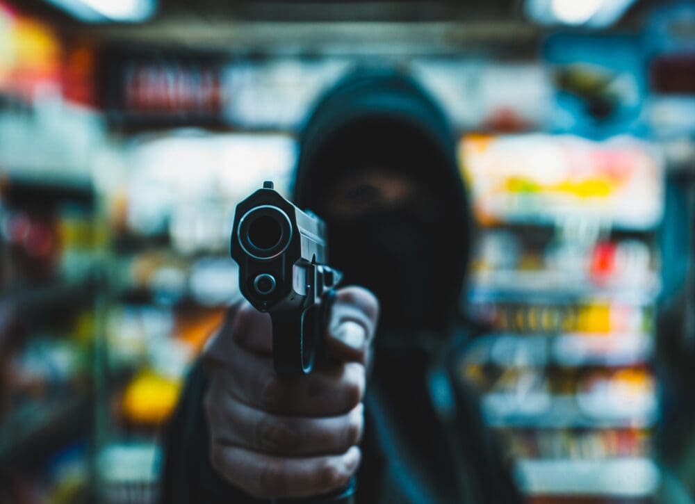 Person,with,a,gun,robbing,a,convenience,store