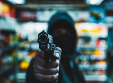 Person,with,a,gun,robbing,a,convenience,store