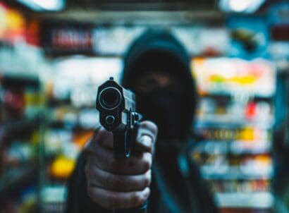 Person,with,a,gun,robbing,a,convenience,store