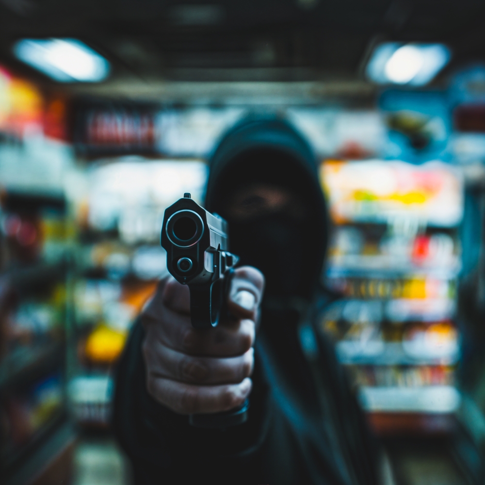 Person,with,a,gun,robbing,a,convenience,store