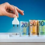 Hand,plugging,an,electric,cable,into,a,power, ,euro