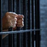 Women's,hands,holding,prison,railings