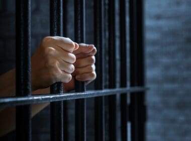 Women's,hands,holding,prison,railings