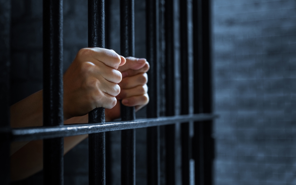 Women's,hands,holding,prison,railings