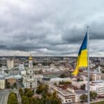 Flag,of,ukraine,close up,with,autumnal,epic,gray,cloudscape,,city