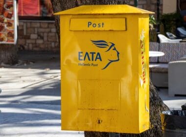 A,yellow,mailbox,of,the,greek,post,office,on,the