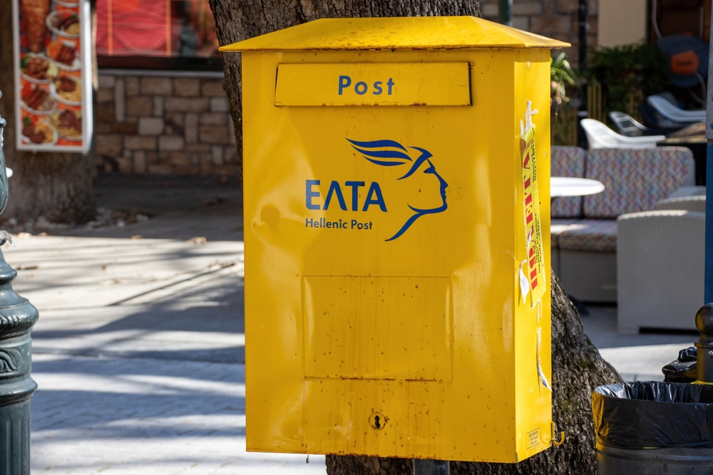 A,yellow,mailbox,of,the,greek,post,office,on,the