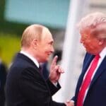 Donald,trump,and,vladimir,putin,shake,hands,at,a,summit,