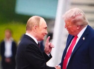 Donald,trump,and,vladimir,putin,shake,hands,at,a,summit,