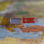 Flags,of,greece,and,turkey,pinned,on,a,map,showing