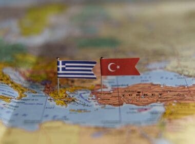 Flags,of,greece,and,turkey,pinned,on,a,map,showing