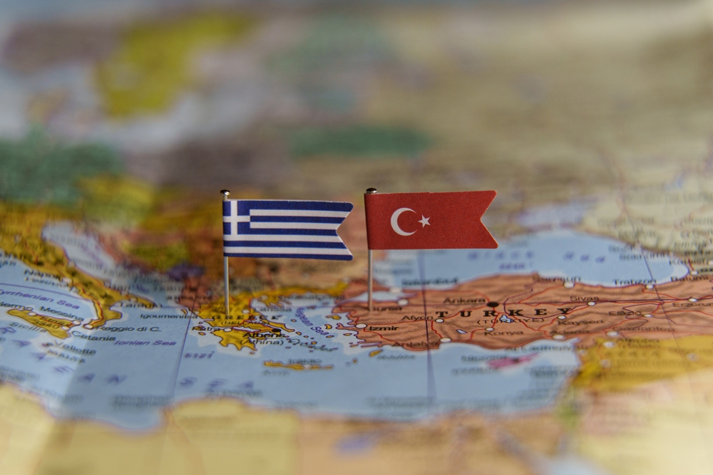 Flags,of,greece,and,turkey,pinned,on,a,map,showing