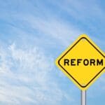 Yellow,transportation,sign,with,word,reform,on,blue,color,sky