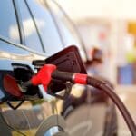 Close up,of,fuel,nozzle,refueling,black,car,at,gas,station