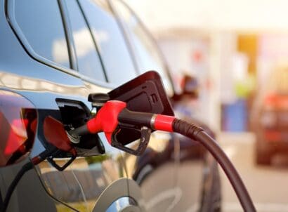 Close up,of,fuel,nozzle,refueling,black,car,at,gas,station