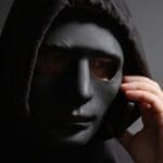 Robber,,a,man,in,a,mask,talking,on,the,phone,