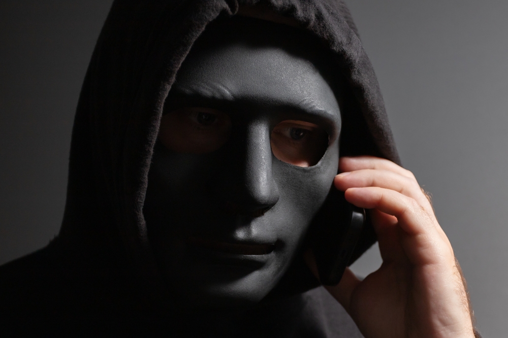 Robber,,a,man,in,a,mask,talking,on,the,phone,
