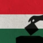 Silhouette,hand,election,vote,on,hungary,flag,wall,background