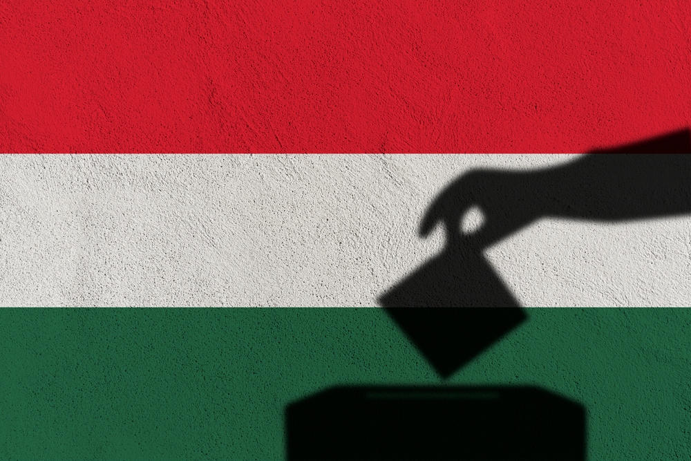 Silhouette,hand,election,vote,on,hungary,flag,wall,background